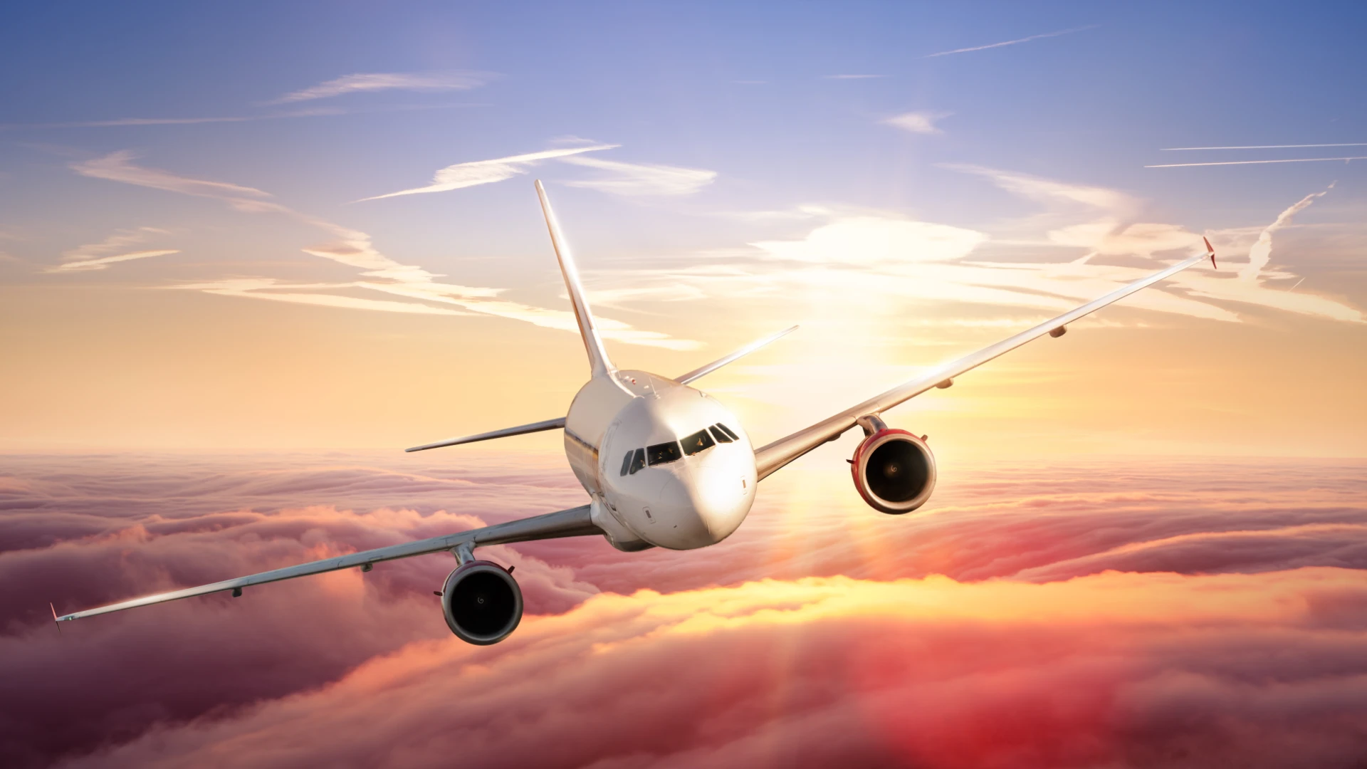Image of plane while flying with beautiful sunset in the background